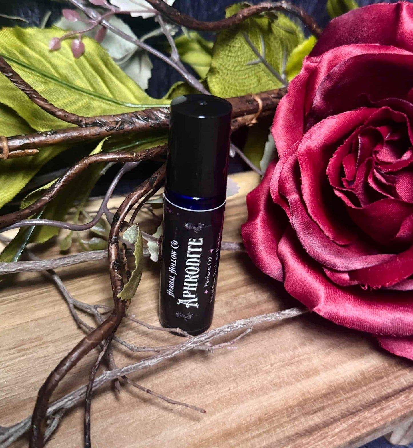 Aphrodite mythology-inspired rollerball fragrance oil perfume, featuring a handcrafted magical rose and peach scent in a portable glass bottle.