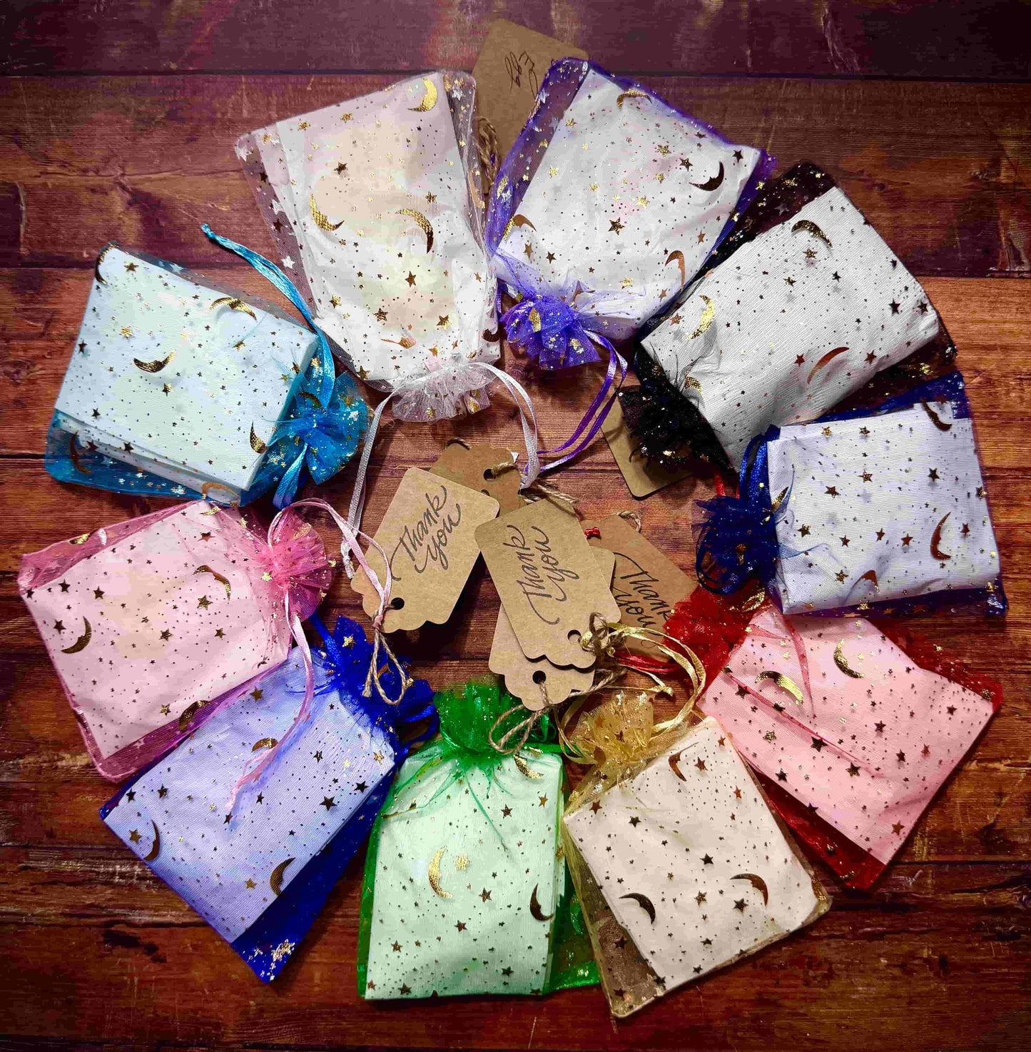 Herbal Hollow Co star-shaped scented wax melts in assorted magical scents, packaged in colorful celestial mesh pouches.