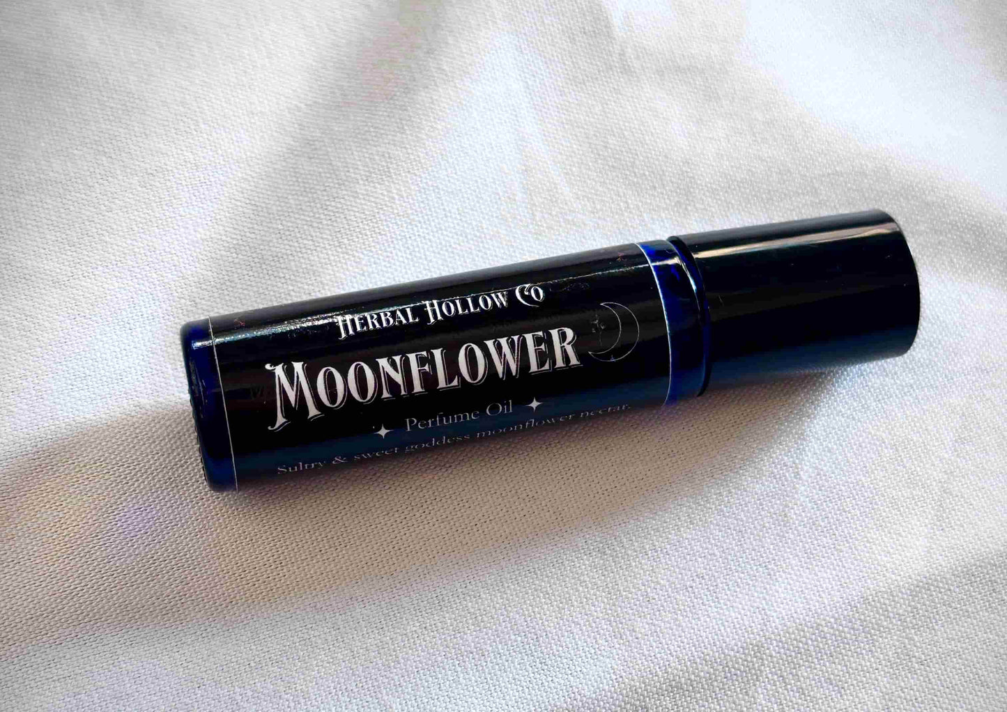 Moonflower dark fantasy-inspired witchy rollerball fragrance oil perfume, featuring a handcrafted magical floral and agave scent in a portable glass bottle.