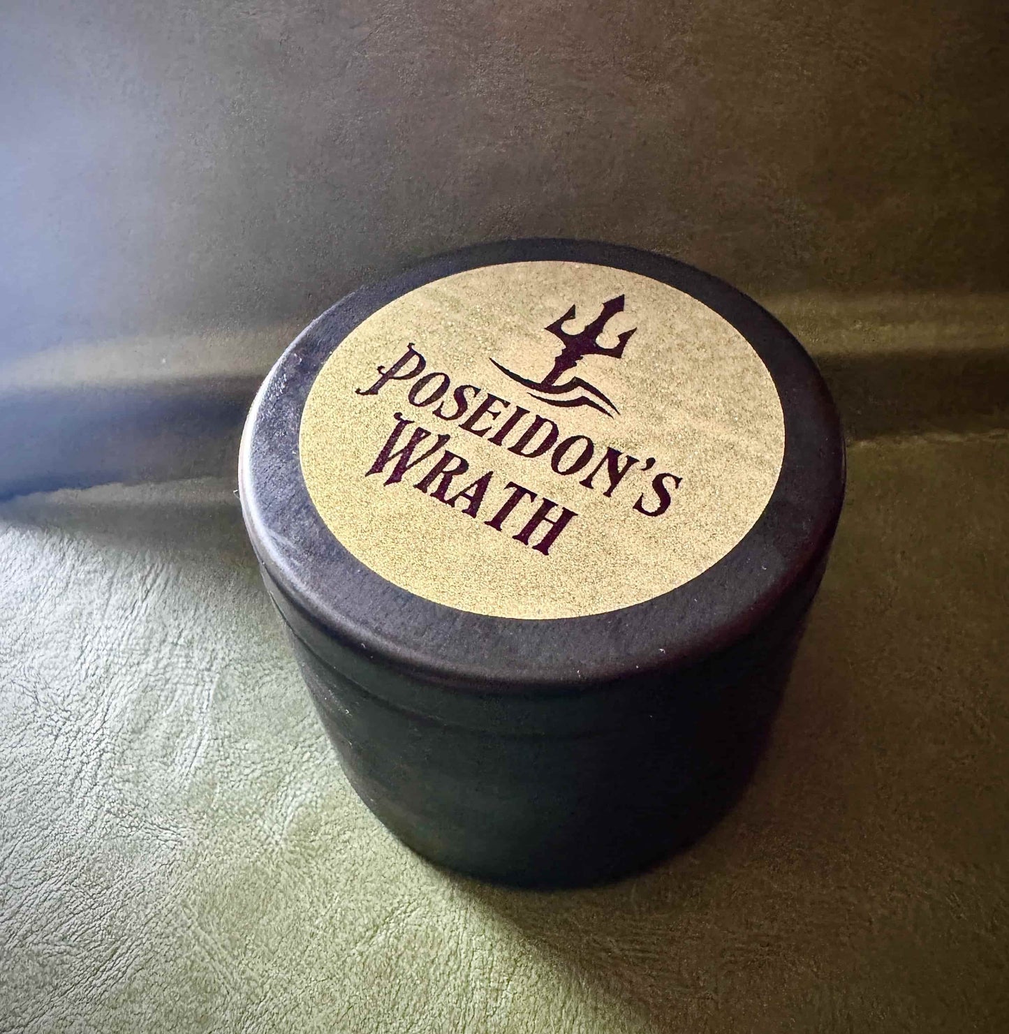 4oz gold labeled. Poseidon candle, a fantasy-inspired handcrafted candle with sea salt, bamboo, dark musk, aloe, petitgrain scent for men in mythology-themed design.