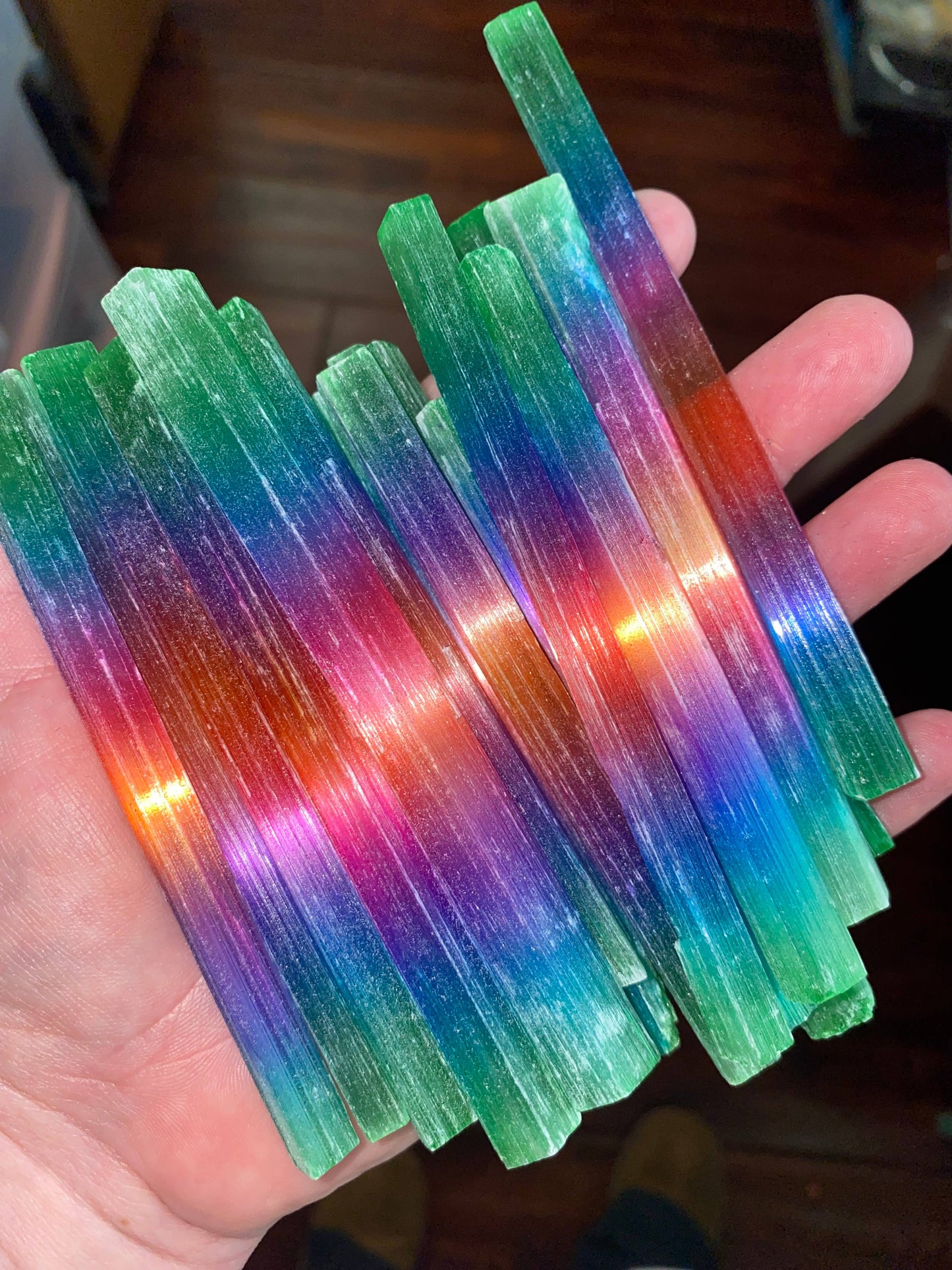 Rainbow-dyed selenite wands — vibrant, energy-cleansing crystal tools perfect for fantasy décor, rituals, and spiritual healing.
