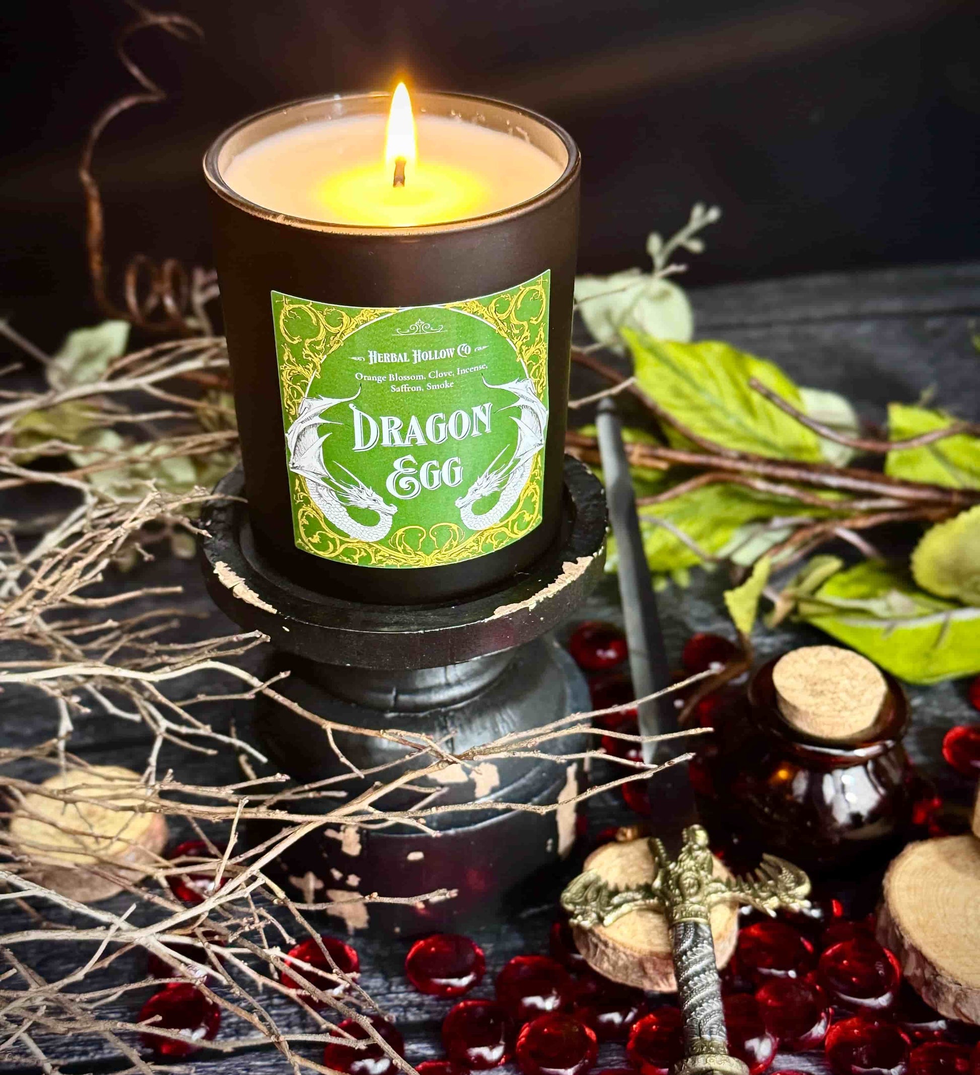 Large Dragon Egg candle, a whimsigoth-inspired handcrafted candle with a orange blossom, clove, incense, saffron, smoky scent in dark fantasy-themed design.