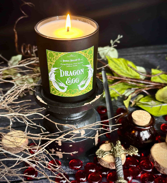 Large Dragon Egg candle, a whimsigoth-inspired handcrafted candle with a orange blossom, clove, incense, saffron, smoky scent in dark fantasy-themed design.