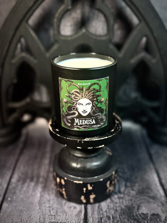Candle with Medusa label on a dark background