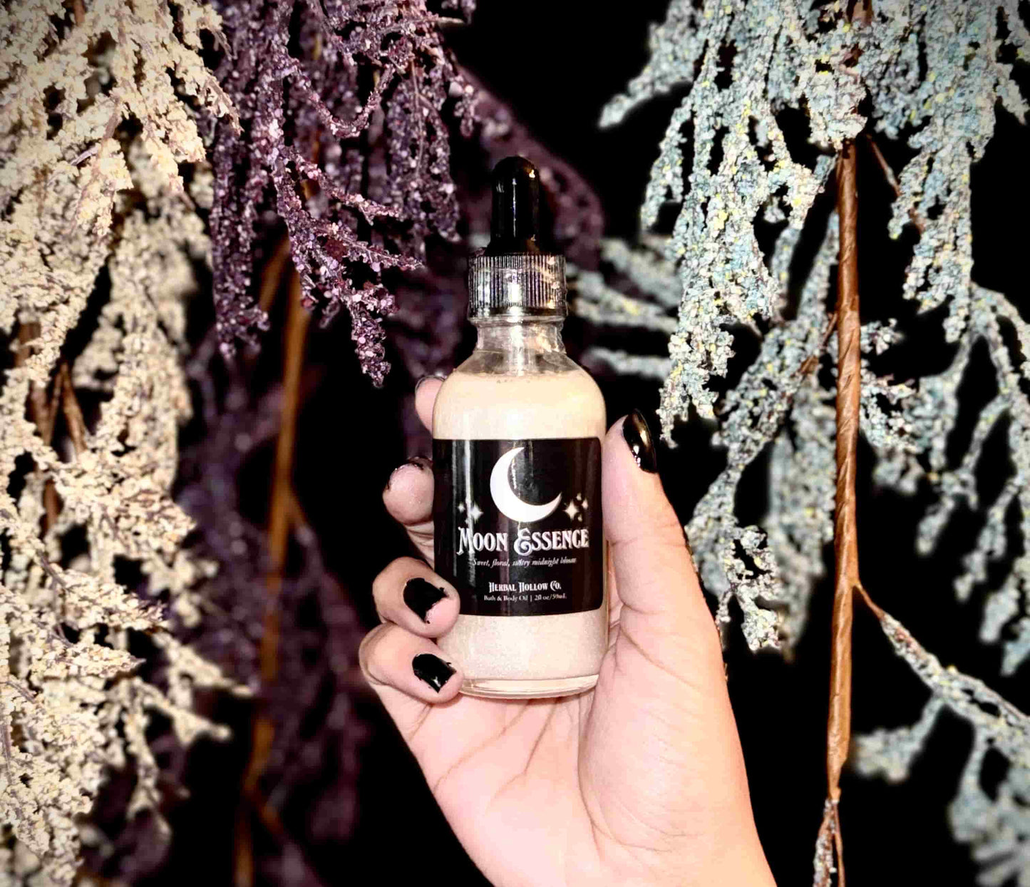 Herbal Hollow Co Moon Essence shimmering body oil with hydrating formula and gold glitter, inspired by fantasy and celestial beauty.