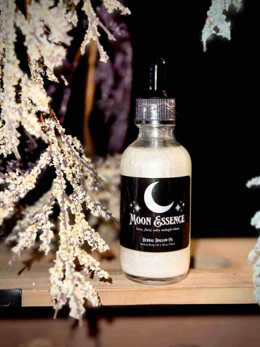 Herbal Hollow Co Moon Essence shimmering body oil with hydrating formula and gold glitter, inspired by fantasy and celestial beauty.