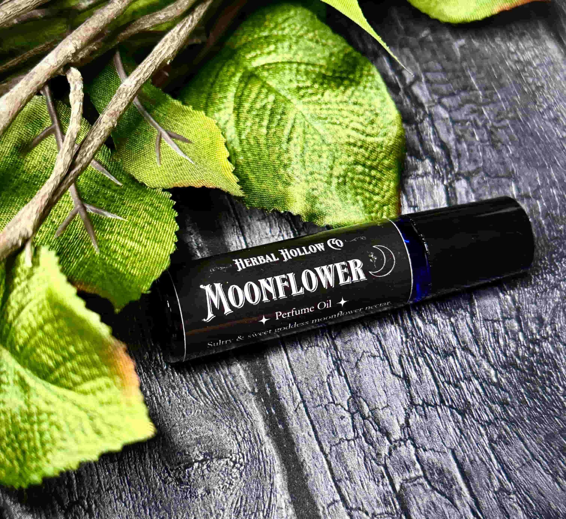 Moonflower dark fantasy-inspired witchy rollerball fragrance oil perfume, featuring a handcrafted magical floral and agave scent in a portable glass bottle.