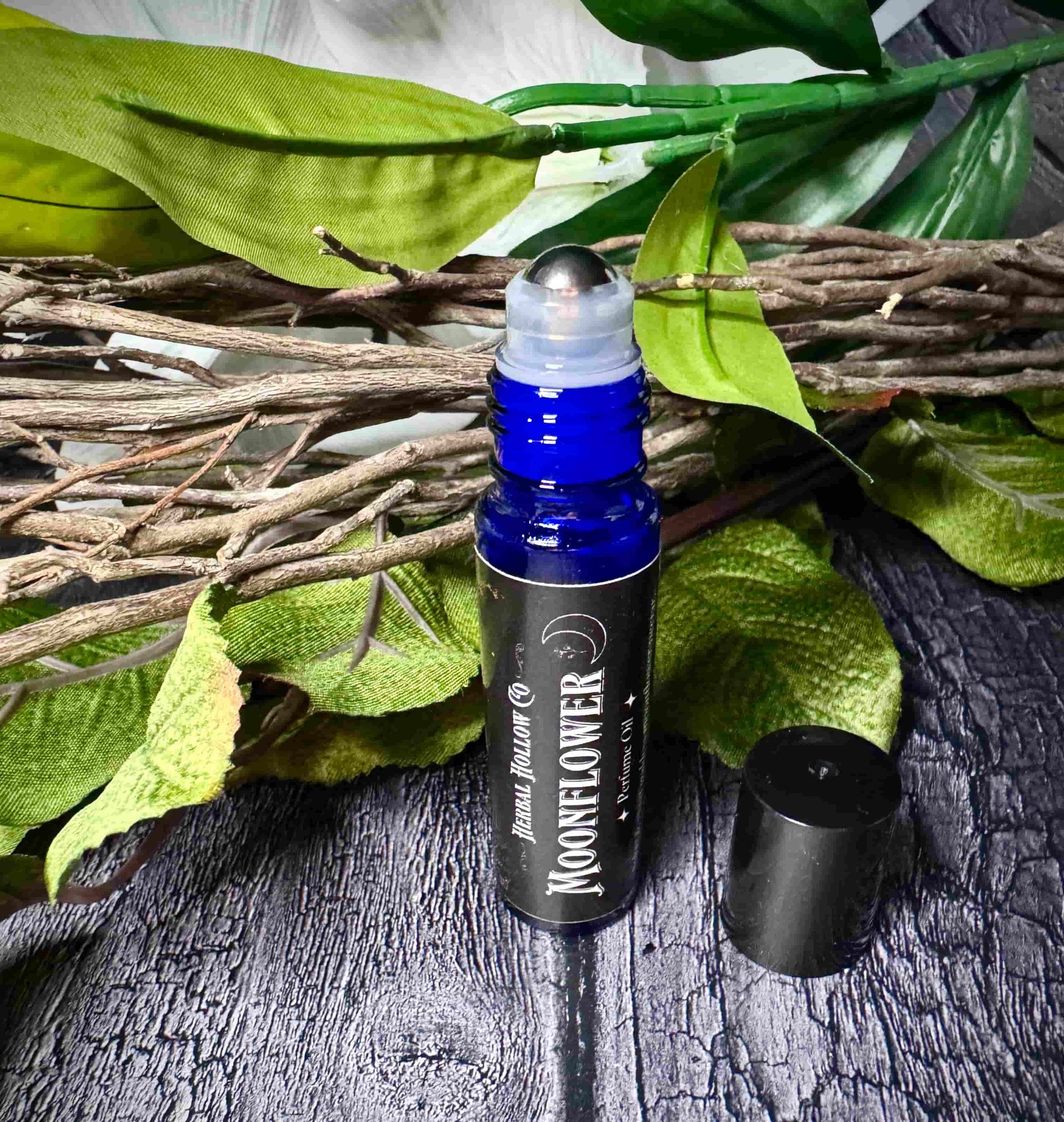Moonflower dark fantasy-inspired witchy rollerball fragrance oil perfume, featuring a handcrafted magical floral and agave scent in a portable glass bottle.