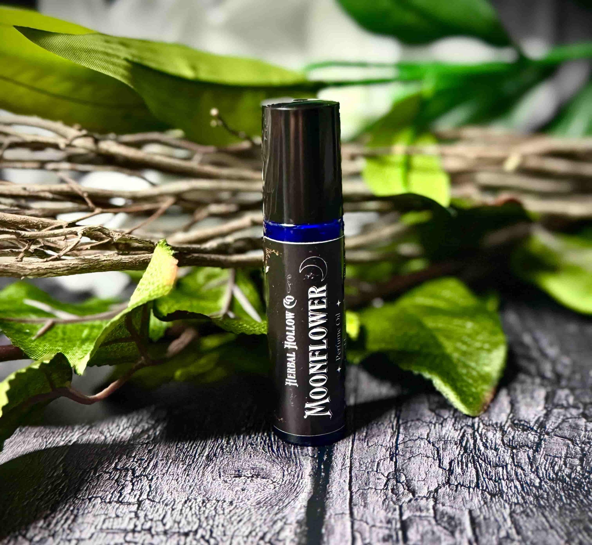 Moonflower dark fantasy-inspired witchy rollerball fragrance oil perfume, featuring a handcrafted magical floral and agave scent in a portable glass bottle.