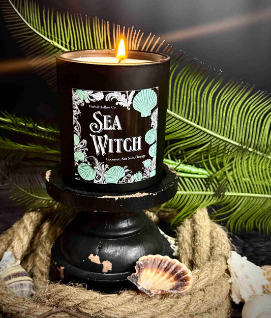 Large Sea Witch candle, a whimsigoth-inspired handcrafted candle with a beauty coconut, sea salt, orange, and orchid scent in mermaid-themed design.
