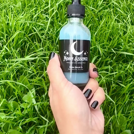 Video of Herbal Hollow Co Moon Essence shimmering body oil with hydrating formula and gold glitter, inspired by fantasy and celestial beauty.
