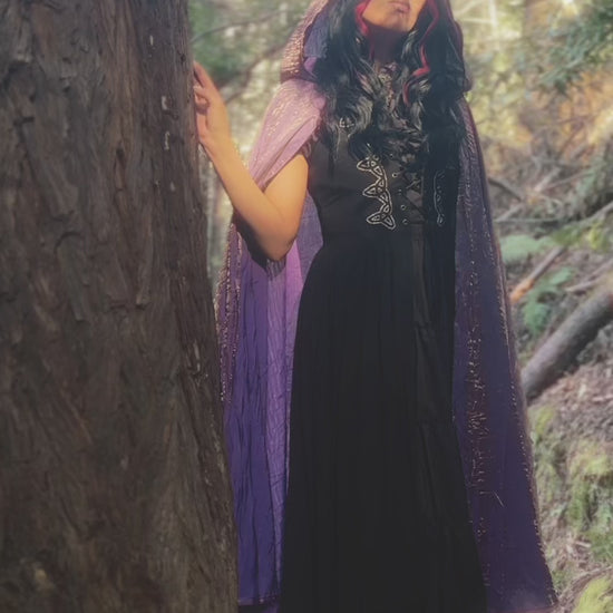 Video of handmade enchanting short and long iridescent lightweight capes in a forest, perfect for renaissance fairs, fantasy costumes, and magical cottagecore fashion.