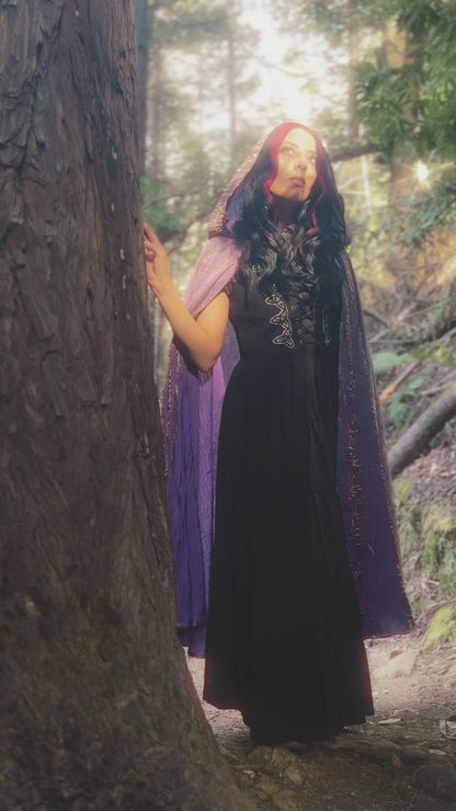 Video of handmade enchanting short and long iridescent lightweight capes in a forest, perfect for renaissance fairs, fantasy costumes, and magical cottagecore fashion.