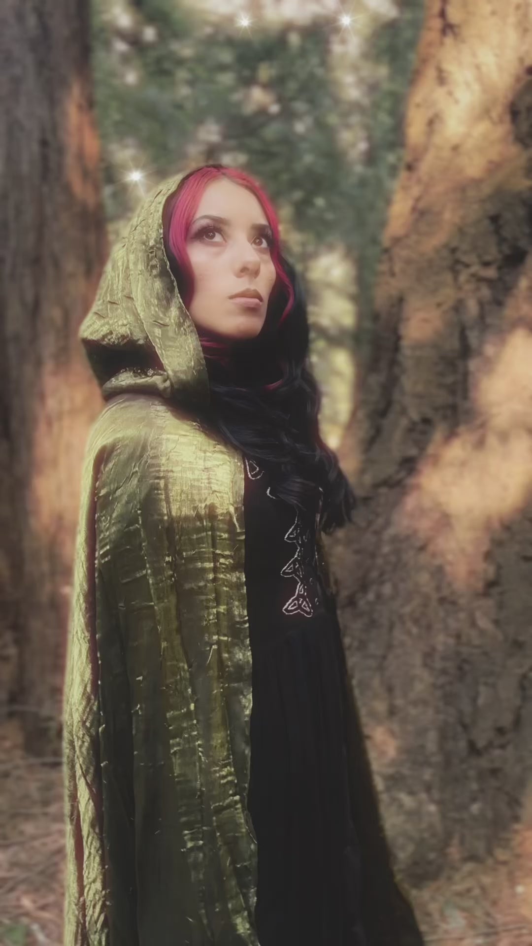 Video of handmade enchanting short and long iridescent lightweight capes in a forest, perfect for renaissance fairs, fantasy costumes, and magical cottagecore fashion.