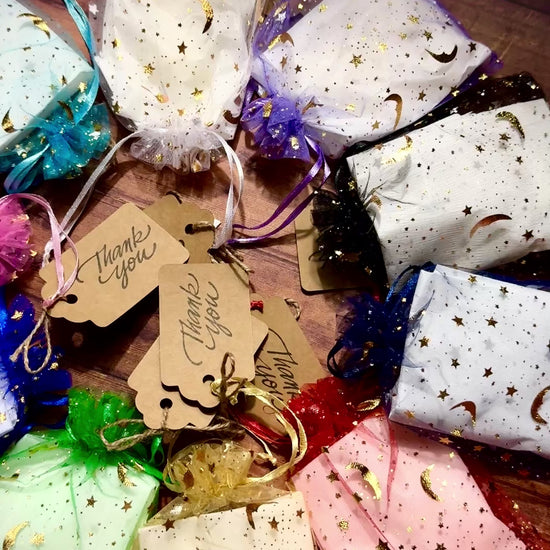 Video of Herbal Hollow Co star-shaped scented wax melts in assorted magical scents, packaged in colorful celestial mesh pouches.