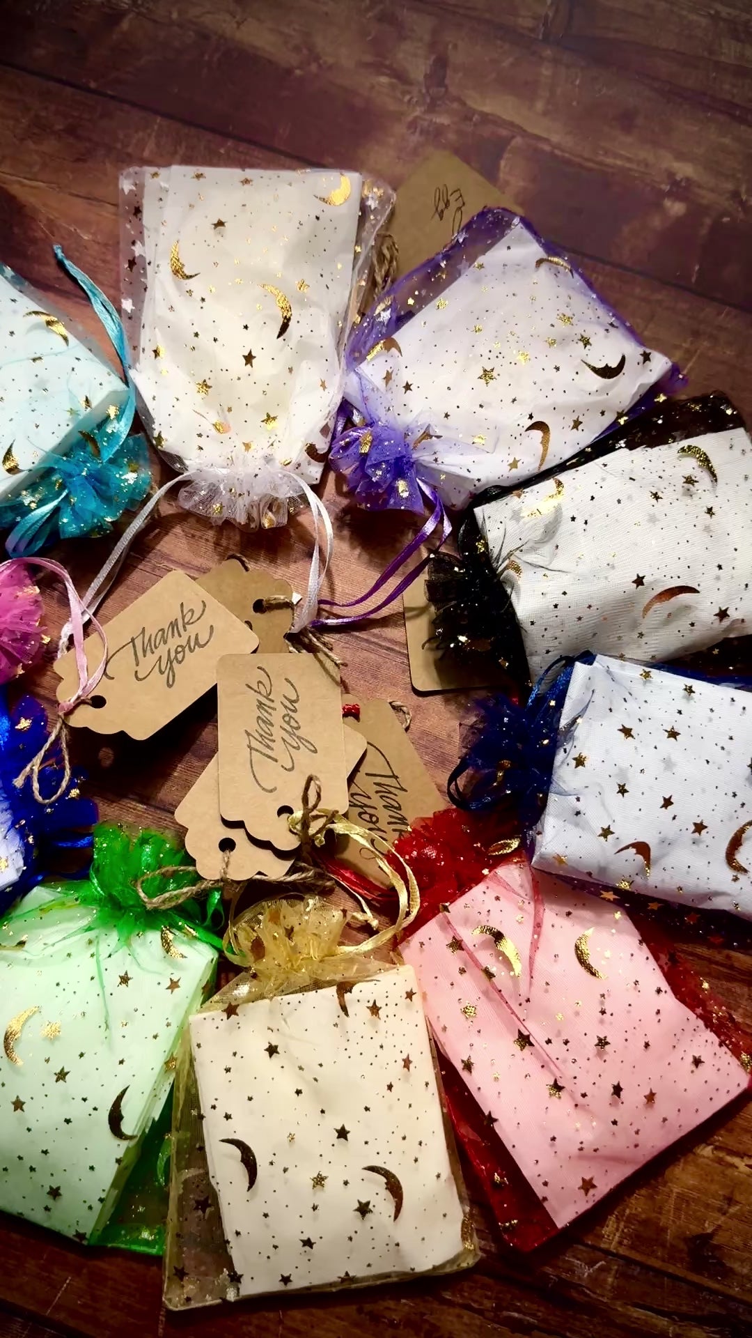 Video of Herbal Hollow Co star-shaped scented wax melts in assorted magical scents, packaged in colorful celestial mesh pouches.