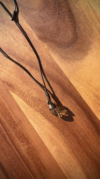 Smoky Quartz crystal on a wooden surface, rotating.