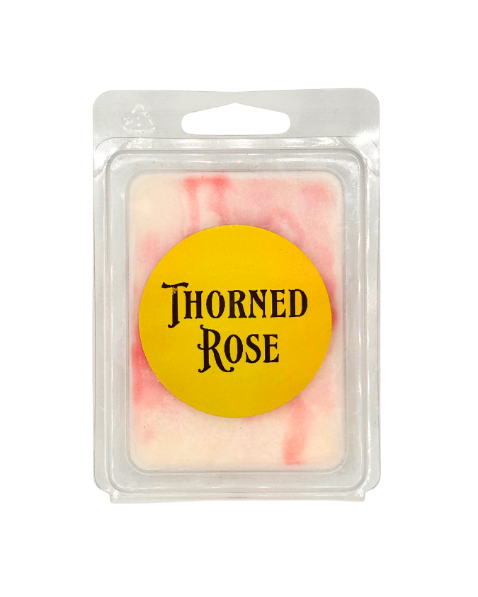 Wax melt in a clear packaging with 'Thorned Rose' label on a white background